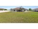 Large backyard with lush lawn and ample space, perfect for outdoor activities at 124 Brandy Chase Blvd, Winter Haven, FL 33880