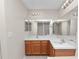 Bright bathroom features a double sink vanity, white countertop and large mirrors at 124 Brandy Chase Blvd, Winter Haven, FL 33880