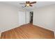 Cozy bedroom with hardwood floors, ceiling fan, and closet for ample storage at 124 Brandy Chase Blvd, Winter Haven, FL 33880