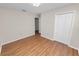 Spacious bedroom with hardwood floors, closet, and light-filled entryway to bathroom at 124 Brandy Chase Blvd, Winter Haven, FL 33880