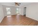 Sunlit bedroom featuring hardwood floors, a ceiling fan, and dual windows at 124 Brandy Chase Blvd, Winter Haven, FL 33880