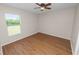 Bright bedroom with hardwood floors and ceiling fan provides a relaxing space at 124 Brandy Chase Blvd, Winter Haven, FL 33880