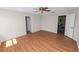 Spacious bedroom with hardwood floors, ceiling fan, and an open doorway to a connected room at 124 Brandy Chase Blvd, Winter Haven, FL 33880