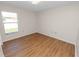 Well-lit bedroom with hardwood floors offers a comfortable and inviting atmosphere at 124 Brandy Chase Blvd, Winter Haven, FL 33880