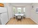 Bright dining area with a white table, matching chairs, and a large bay window at 124 Brandy Chase Blvd, Winter Haven, FL 33880