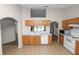 Classic kitchen with wooden cabinets, white appliances, and a bright window above the sink at 124 Brandy Chase Blvd, Winter Haven, FL 33880