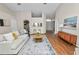 Well-lit living room with hardwood floors, fireplace, and seamless transition to the kitchen area at 124 Brandy Chase Blvd, Winter Haven, FL 33880