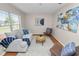 Comfortable living room with natural light, stylish decor, and wood laminate flooring at 124 Brandy Chase Blvd, Winter Haven, FL 33880