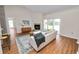 Comfortable living room featuring a fireplace, sliding glass doors, and hardwood floors at 124 Brandy Chase Blvd, Winter Haven, FL 33880