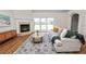 Inviting living room featuring a fireplace, sliding glass doors, and hardwood floors at 124 Brandy Chase Blvd, Winter Haven, FL 33880