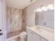 Beautifully remodeled bathroom features a marble look shower and stylish fixtures at 135 Kenilwood Ln, Lakeland, FL 33809