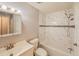Bright bathroom featuring a bathtub with white marble-patterned tile surround and a classic vanity at 135 Kenilwood Ln, Lakeland, FL 33809