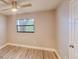 Bright bedroom with new wood flooring, ceiling fan, and large window at 135 Kenilwood Ln, Lakeland, FL 33809
