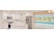 Modern kitchen featuring white cabinets, stainless steel appliances, and a view of the pool at 135 Kenilwood Ln, Lakeland, FL 33809