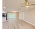 Spacious open concept living room featuring view to pool and modern lighting at 135 Kenilwood Ln, Lakeland, FL 33809