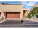 Unique home exterior with a brown garage door, brick pathway, and distinctive architectural design at 14 Casarena Ct, Winter Haven, FL 33881