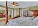 Large main bedroom with hardwood floors, a four-poster bed, and a closet with mirrored doors at 14 Casarena Ct, Winter Haven, FL 33881