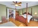 Charming main bedroom with a four-poster bed, hardwood floors, and French doors leading to another room at 14 Casarena Ct, Winter Haven, FL 33881