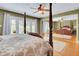 Inviting main bedroom featuring hardwood floors, a four-poster bed, and mirrored closet doors at 14 Casarena Ct, Winter Haven, FL 33881