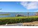 Scenic waterfront view featuring a private dock and lush landscaping at 14 Casarena Ct, Winter Haven, FL 33881