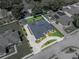 Overhead view of a beige single-Gathering home with a screened-in pool, manicured lawn, and circular driveway at 152 Melissa Trl, Auburndale, FL 33823