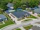 Stunning aerial view of a beige single-Gathering home featuring a well-manicured lawn and circular driveway at 152 Melissa Trl, Auburndale, FL 33823