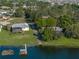 Waterfront homes with private docks surrounded by lush trees and tranquil lake waters at 152 Melissa Trl, Auburndale, FL 33823