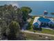 Aerial view of a lakefront home with private dock, a manicured lawn, and mature trees at 152 Melissa Trl, Auburndale, FL 33823
