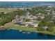Waterfront neighborhood featuring homes with manicured lawns, private docks, and serene lake views at 152 Melissa Trl, Auburndale, FL 33823