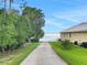Spacious backyard leading to the waterfront, featuring a private dock and lush greenery at 152 Melissa Trl, Auburndale, FL 33823