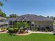 A beautiful backyard showcasing a screened-in pool, lush landscaping, and a well-maintained exterior at 152 Melissa Trl, Auburndale, FL 33823