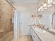 Well-lit bathroom with a shower-tub combination, neutral tile, a vanity, and ample lighting at 152 Melissa Trl, Auburndale, FL 33823