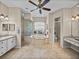 Bright bathroom with a double sink vanity, large soaking tub, a glass-enclosed shower, and tile flooring at 152 Melissa Trl, Auburndale, FL 33823