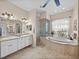 Bright bathroom with double sink vanity, walk in shower and separate tub with garden window at 152 Melissa Trl, Auburndale, FL 33823