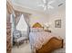 Charming bedroom featuring a wooden bed frame, soft carpet, and a window with patterned drapes at 152 Melissa Trl, Auburndale, FL 33823