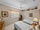 Cozy bedroom featuring two twin beds, complemented by a ceiling fan and ample natural light from the window at 152 Melissa Trl, Auburndale, FL 33823