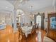 Dining room featuring decorative light fixture, custom window treatments, and hardwood floors at 152 Melissa Trl, Auburndale, FL 33823