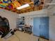 Organized garage interior with storage shelves, overhead storage, and work area at 152 Melissa Trl, Auburndale, FL 33823