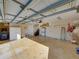 Spacious garage interior with ample storage, a door to the house, and epoxy floors at 152 Melissa Trl, Auburndale, FL 33823