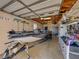 Well-organized garage interior with a boat, trailer, tools, and storage racks at 152 Melissa Trl, Auburndale, FL 33823