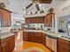 Open kitchen with stainless steel dishwasher and sink, connecting to an expansive living room at 152 Melissa Trl, Auburndale, FL 33823