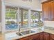 Kitchen sink with granite countertop, offering a view of the backyard pool and patio at 152 Melissa Trl, Auburndale, FL 33823