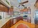 Traditional kitchen boasts granite countertops, stainless steel appliances, and cherry wood cabinetry at 152 Melissa Trl, Auburndale, FL 33823