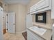 Bright laundry room featuring white cabinetry, utility sink, beige walls, and a tile floor at 152 Melissa Trl, Auburndale, FL 33823
