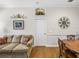 Cozy living room featuring a comfortable sofa, wooden table, and decorative wall art at 152 Melissa Trl, Auburndale, FL 33823