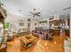 Spacious living room with hardwood floors, sofas, and kitchen view, creating an open concept layout at 152 Melissa Trl, Auburndale, FL 33823