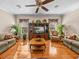 Living room with hardwood floors, sofas, an entertainment center, and natural light from windows at 152 Melissa Trl, Auburndale, FL 33823