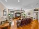 Spacious living room with hardwood floors, multiple sofas, and a large entertainment center at 152 Melissa Trl, Auburndale, FL 33823