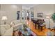 Bright living room featuring a decorative rug, a piano and hardwood floors at 152 Melissa Trl, Auburndale, FL 33823