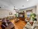 Wide angle view of a living room featuring wood floors, sofas, and built-in entertainment center at 152 Melissa Trl, Auburndale, FL 33823